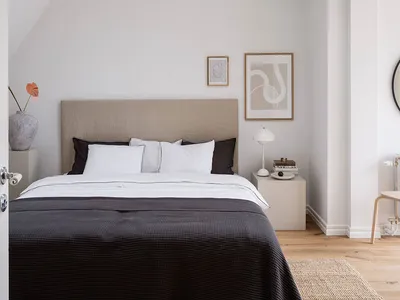 Minimalist bedroom with a bed, white walls, and a skylight window.
