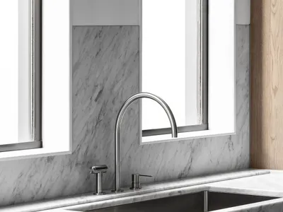 Modern kitchen featuring marble countertops and backsplash with a sleek, minimalistic design.