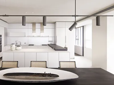 A modern, minimalist kitchen with white cabinets and a sleek, white countertop.