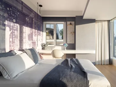Modern minimalist bedroom with a wooden floor, large window, and city view.