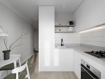 A minimalist kitchen with white cabinets and a modern design.