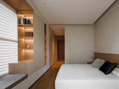 A modern minimalist bedroom with wood and concrete elements