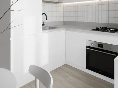 Modern kitchen area with white cabinets, wooden floor, and white tiles on the walls.