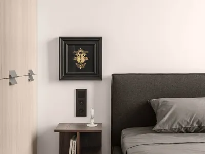 A minimalist bedroom featuring a grey upholstered bed, a wooden bedside table, and a wall-mounted bedside lamp. The decor inc