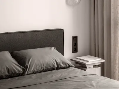 Neutral materials in a minimalist bedroom setting.