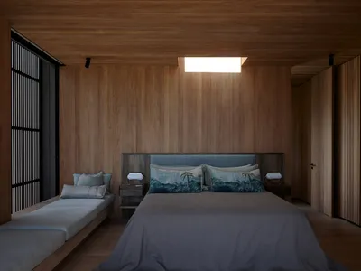 A minimalist bedroom with wooden paneling, a large bed, and a window with wooden blinds.