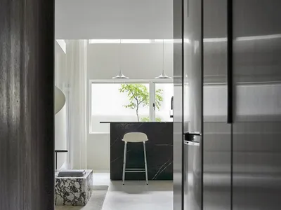 Modern kitchen featuring a marble countertop and stainless-steel appliances.