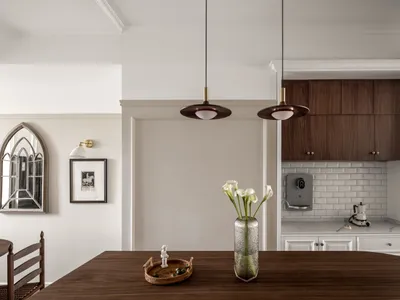 A modern kitchen featuring wooden elements and a marble backsplash.