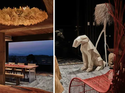Modern restaurant interior featuring wooden furniture and a view of a balcony overlooking the mountains.