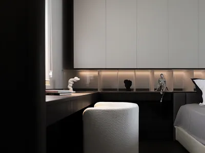 A minimalist bedroom featuring modern furniture and neutral color palette.