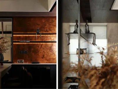 Modern kitchen interior with metallic accents and floating shelves.