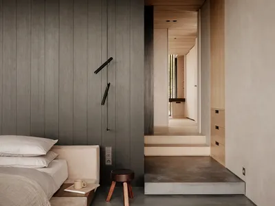 Modern minimalist bedroom featuring concrete floor and wooden accents, with a bed and minimalist furniture.