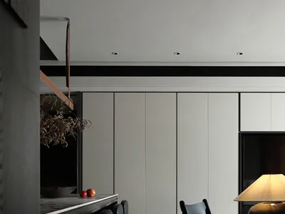 Modern minimalist kitchen featuring a football field-inspired LED lighting setup and a stylish mango wood chair.