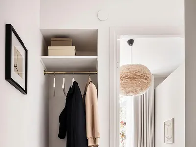 A minimalist bedroom featuring neutral tones with a cozy bed and simple decor.