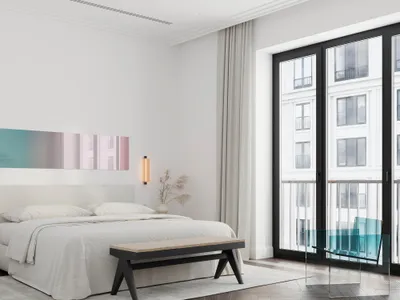 A modern bedroom with a neutral-toned color palette and a large window.