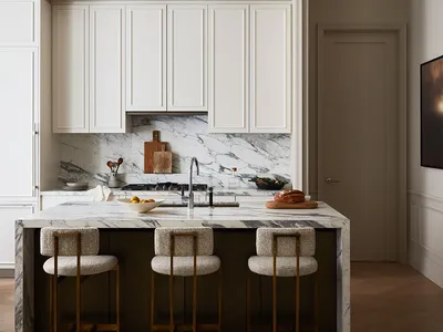 Modern kitchen featuring a marble countertop and white cabinets.