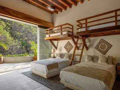 A minimalist bedroom featuring wooden furnishings and a natural outdoor view.