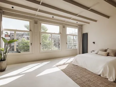 A minimalist bedroom with light-colored wood flooring, white walls, and large windows.