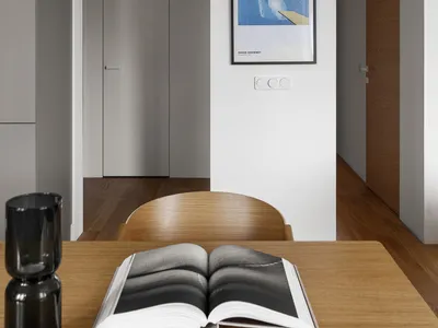 A modern home office with a wooden desk and white walls.