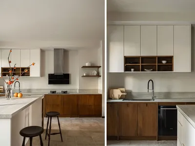 Modern kitchen with wooden cabinets, marble countertops, and stainless steel appliances.