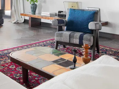 A living room featuring industrial design elements such as wood, ceramic tiles, and fabric.