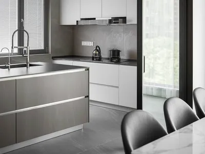Modern minimalistic kitchen with concrete walls and white cabinetry