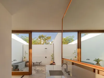 Modern minimalist kitchen featuring marble countertops and a sleek design.