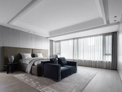 A modern minimalist bedroom featuring textured wall paneling