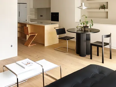 A modern kitchen with wooden finishes and minimalist design elements