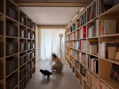 A modern library with wooden bookshelves and metal wire containers.