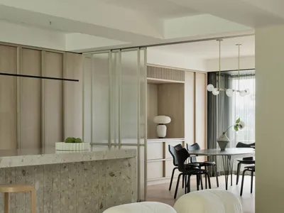 Modern interior design featuring a marble countertop and cozy, wool-textured sofa in minimalist living room setting