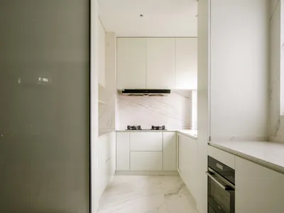 Modestly designed white marble kitchen with minimalist aesthetics