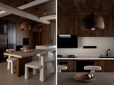 Modern kitchen with stone and concrete finishes, featuring a dining table and chairs.
