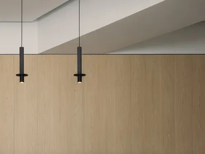 A modern kitchen with wooden cabinets and a marble countertop and floor.