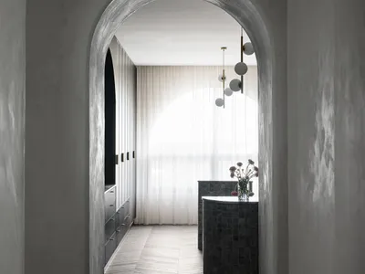 Interior of a modern minimalist kitchen featuring concrete walls and wooden tiles