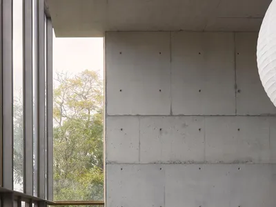Minimalist bedroom with concrete and glass materials