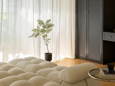 A living room with fabric curtains and wooden furniture