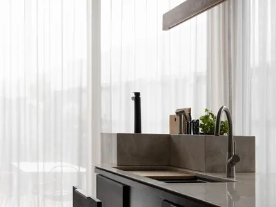 Modern kitchen featuring stainless steel appliances and marble countertops.