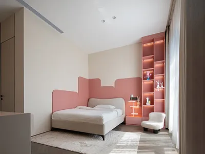 A modern bedroom featuring a pink bed, white chairs, a pink bookshelf illuminated by lights, and white curtains.