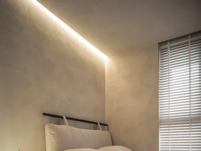 Minimalist bedroom with concrete walls and wood furniture