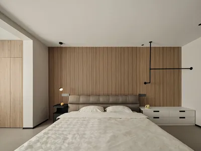 Modern minimalist bedroom with a wood paneled wall, featuring a large bed with white linens and a sleek, contemporary design.