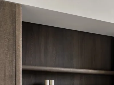 A modern minimalist kitchen with concrete and wood finishes and white shelves.