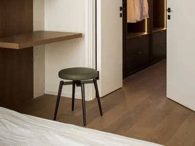 Modern bathroom featuring marble, wood, and metal elements.