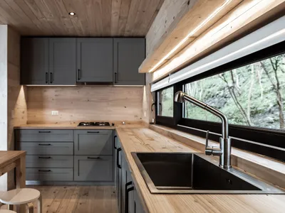 A modern kitchen with wooden countertops and metal sink.
