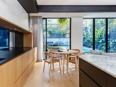 Modern kitchen with marble countertops and glass windows showcasing contemporary design