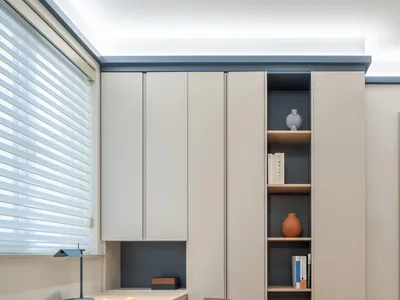 A minimalist home office featuring neutral-toned furniture and decor.