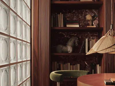 A well-designed home office featuring wooden shelving and a round wooden table with a green cushioned chair.