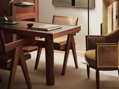 Modern interior design featuring wooden furniture and leather accents in a home office setting.