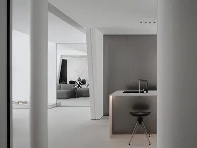 Modern minimalist kitchen featuring concrete and metal finishes.