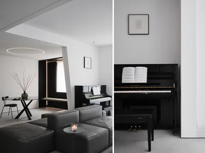 A modern minimalist living room with a black piano, leather seating, and sleek design elements.